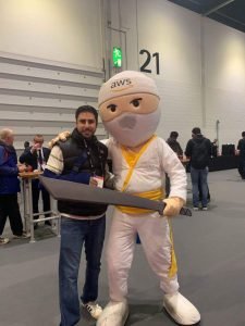 Arif with the AWS Mascot at the AWS Summit