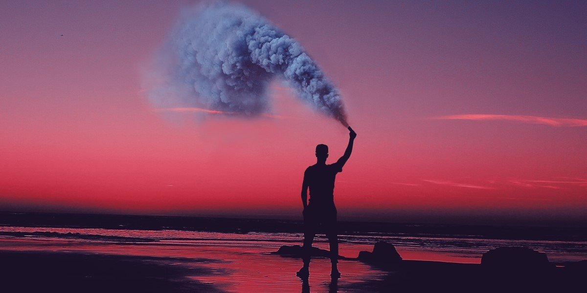 A man sprays gas on a beach